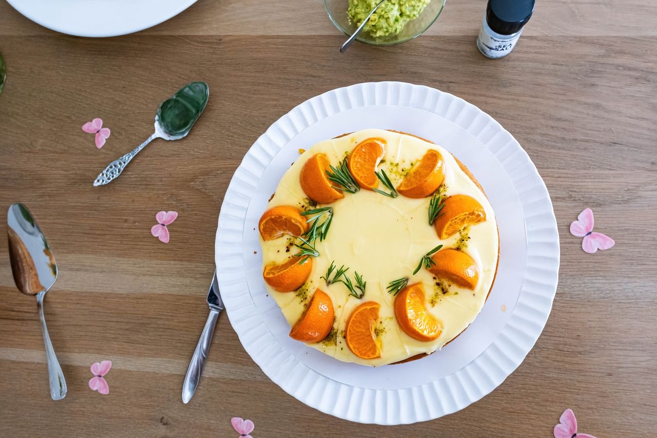 Mastering the First Impression: Your intriguing post title goes here Delicious orange and rosemary cake presented on a wooden table with decorative flowers.