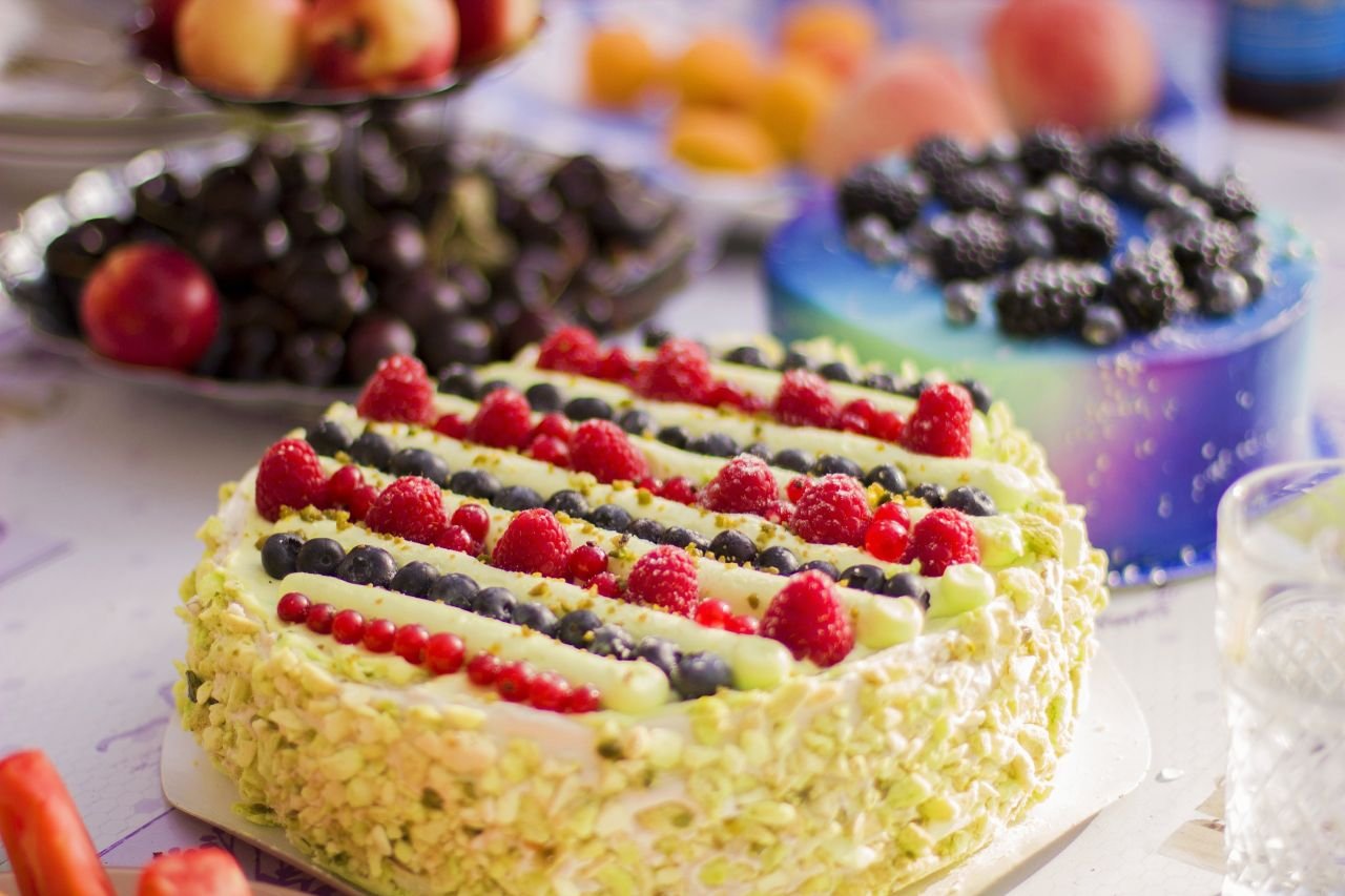 The Art of Drawing Readers In: Your attractive post title goes here Vibrant fruit-topped and marbled cakes on table, perfect for food photography needs.